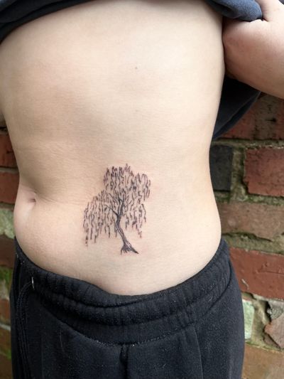 Elegant fine line tree tattoo by Emily Bonnet, featuring intricate details and delicate design.