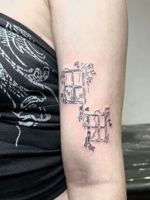 Capture the beauty of the world outside with this delicate and detailed window tattoo by Emily Bonnet. Perfect for those who appreciate fine line and illustrative styles.