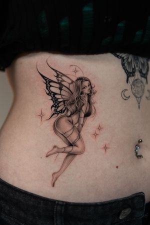 Beautiful black and gray illustrative tattoo featuring a fairy pin up by Ion Caraman.
