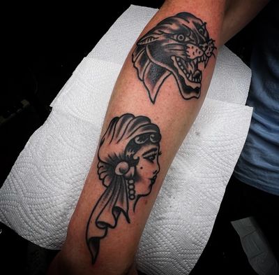 Capture the fierce beauty of a panther and mysterious allure of a gypsy woman with this traditional tattoo by Alessandro Lanzafame.