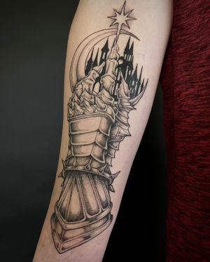 Illustrative tattoo by Kat Jennings featuring a mystical moon, intricate gauntlet, armored castle design.