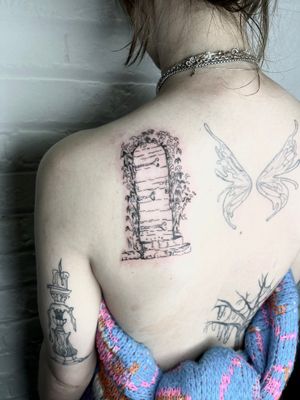 Explore the intricate details of an elegant door in this fine line, illustrative tattoo by Emily Bonnet.