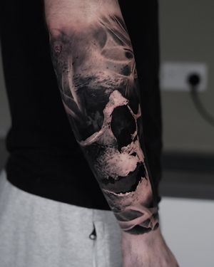 Detailed black and gray tattoo of a skull done by the talented artist Milan Boros, showcasing his expertise in realism.