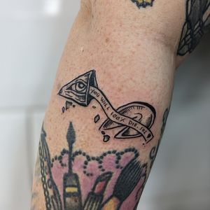 Get inspired with a unique illustrative tattoo by artist Adam McDade featuring a meaningful quote inside a fortune cookie motif.