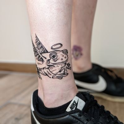 Get a unique illustrative frog tattoo done by talented artist Adam McDade. The design is playful and full of personality.