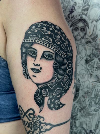Capture the mystique of a gypsy woman with this classic traditional tattoo by Jakob Isaac.