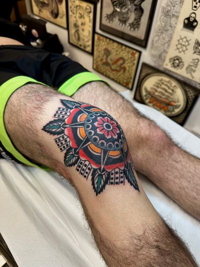 Get inked by the talented Jakob Isaac with this stunning traditional tattoo featuring a beautiful flower mandala design.