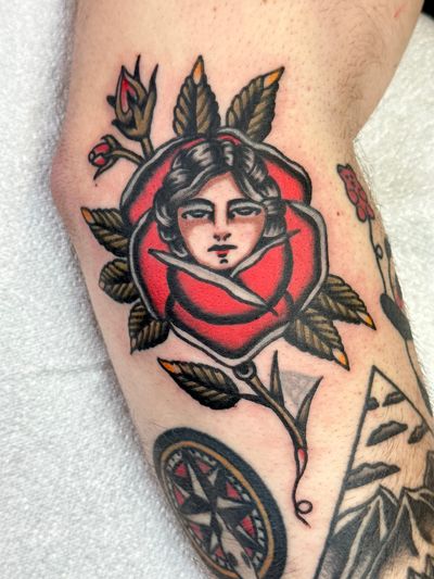 A stunning traditional tattoo of a rose lady by the talented artist Jakob Isaac, blending feminine beauty and timeless elegance.