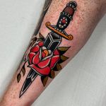 Classic traditional tattoo design featuring a bold rose and dagger motif by Jakob Isaac.