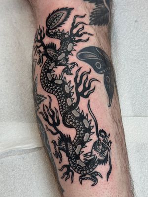 Discover the mythical power of a traditional dragon tattoo designed by the talented artist Jakob Isaac. Unleash your inner strength and courage with this timeless piece.