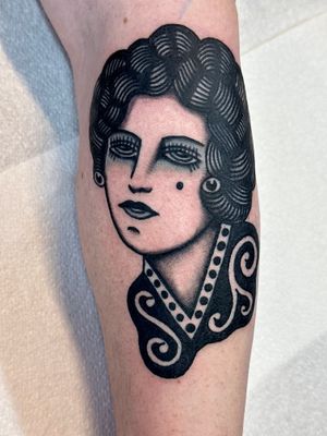 Experience the timeless beauty of a traditional lady tattoo by renowned artist Jakob Isaac. Perfect for those who appreciate classic artistry.