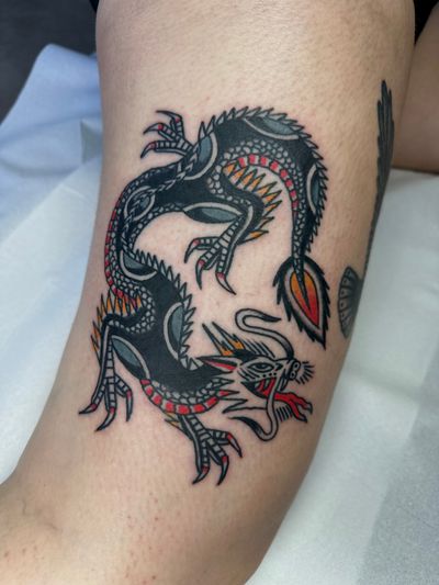 Experience the power and mystique of a traditional dragon tattoo expertly crafted by the talented artist Jakob Isaac.