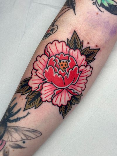 Experience the timeless beauty of a traditional peony flower tattoo crafted by the talented artist Jakob Isaac.