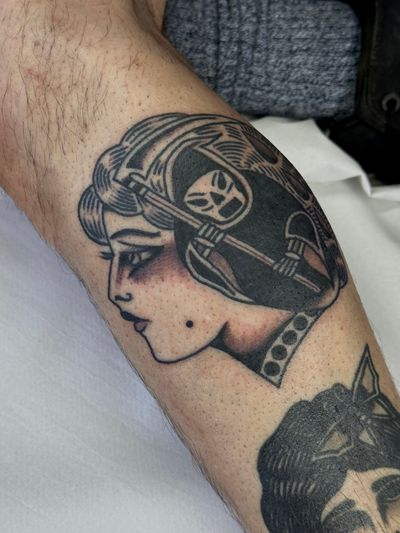Get inked by Jakob Isaac with a stunning traditional tattoo featuring a lady and reaper motif.