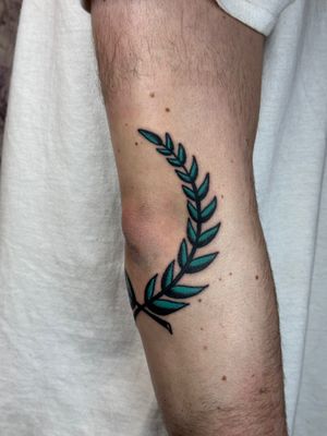 Beautiful traditional tattoo featuring a laurel branch motif, expertly done by Jakob Isaac.