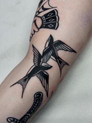 Get a timeless traditional swallow tattoo designed by the talented artist Jakob Isaac, perfect for those who appreciate classic ink.