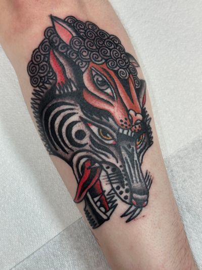 Experience the timeless struggle between predator and prey with this stunning traditional tattoo by Jakob Isaac.