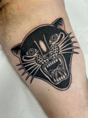 Get inked by Jakob Isaac with a fierce panther design in classic traditional style. Make a statement with this timeless piece.