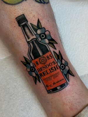 Get a classic illustrative bottle tattoo by the skilled artist Jakob Isaac, combining traditional style with modern flair.
