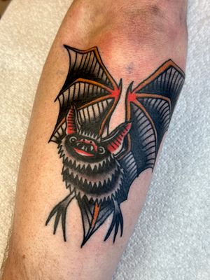 Get a timeless and classic traditional style bat tattoo by the talented artist Jakob Isaac. Perfect for fans of bold, vibrant designs.