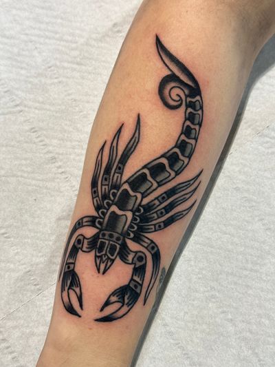 Get inked with a fierce scorpion design by Jakob Isaac in classic traditional style. Stand out with this bold and striking tattoo!
