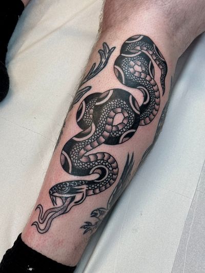 Embrace the classic artistry of a traditional snake tattoo by the talented Jakob Isaac. Let the serpent's mystique adorn your skin with this timeless design.