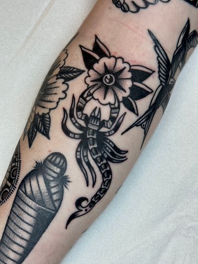 Exquisite traditional tattoo featuring a scorpion and a flower, expertly done by Jakob Isaac.
