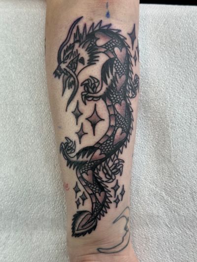 Get a fierce and timeless traditional dragon tattoo by the talented artist Jakob Isaac. Perfect for lovers of classic tattoo art.
