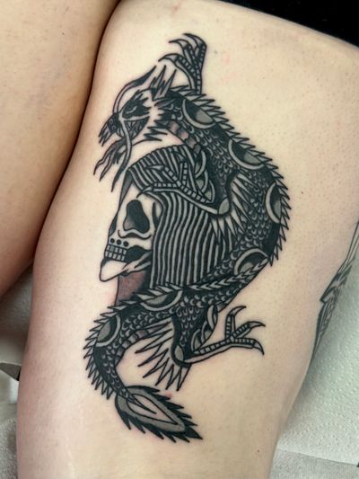 Experience the powerful symbolism of the dragon and grim reaper in this traditional tattoo by Jakob Isaac.
