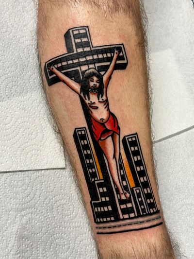 Celebrate your faith with this stunning traditional tattoo featuring a cross and Jesus, expertly crafted by the talented artist Jakob Isaac.