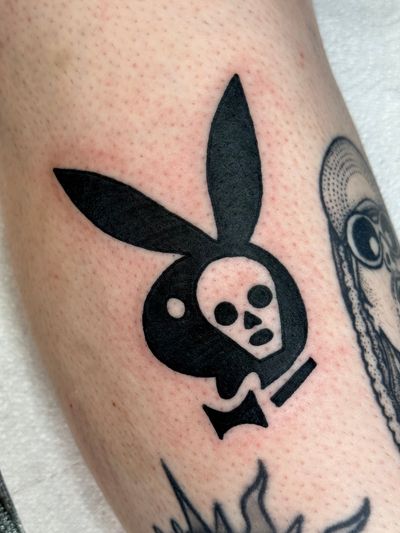 Unique tattoo design by Jakob Isaac featuring a fusion of bunny, skull, and playboy logo motifs.