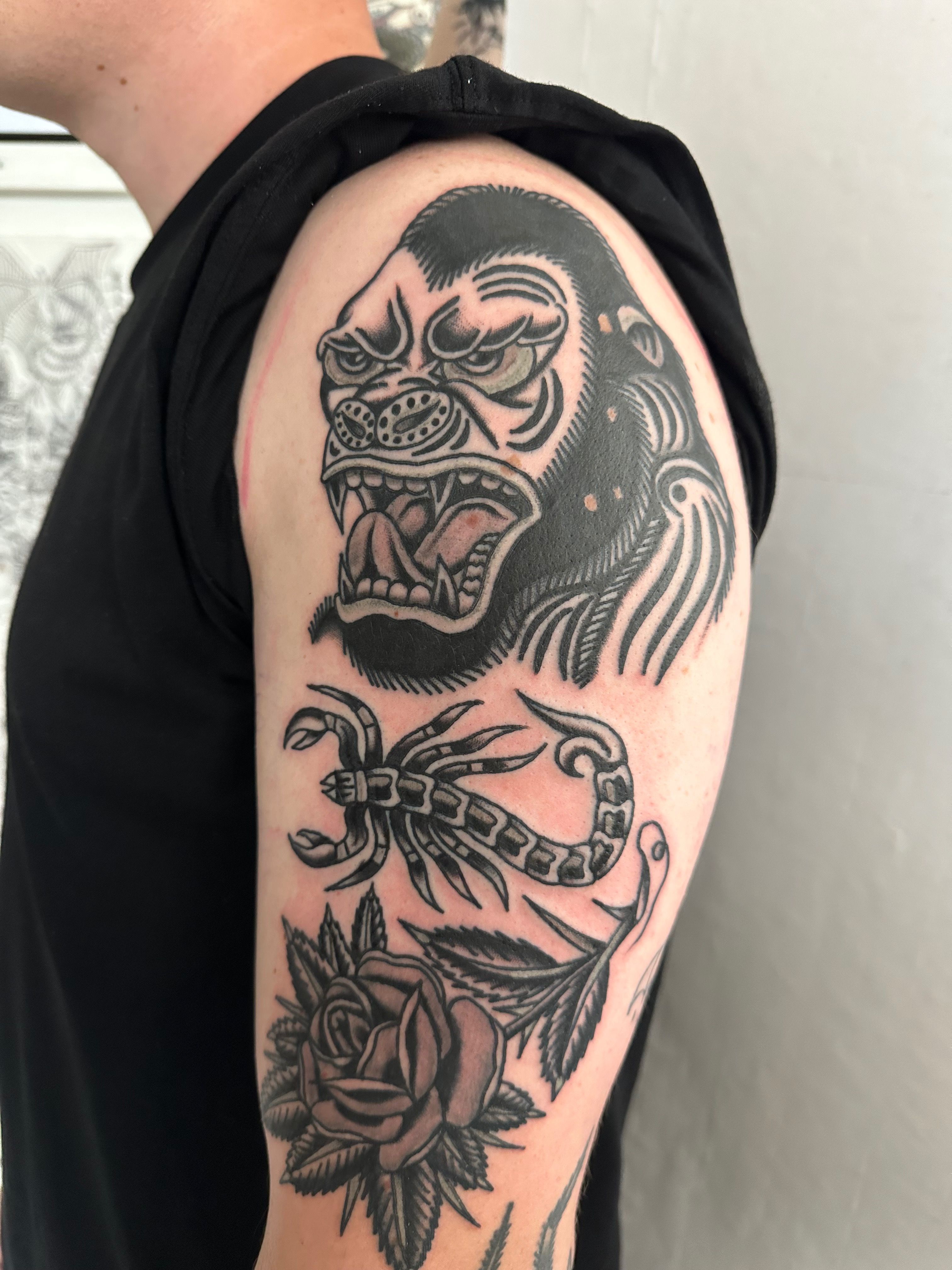 starry-snake790: tattoo on shoulder black outline orangutan theme