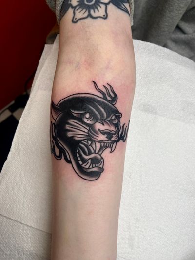 Get fierce with this stunning traditional panther tattoo, expertly done by renowned artist flashbyaj. Perfect for those seeking a classic yet powerful tattoo design.