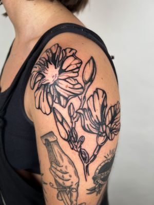 Admire the intricate details of this illustrative floral tattoo by renowned artist Jack Howard.