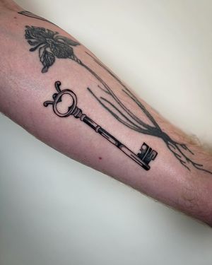 Unlock your creativity with this beautifully detailed key tattoo by Jack Howard. Perfect for those who appreciate fine artistry in body ink.