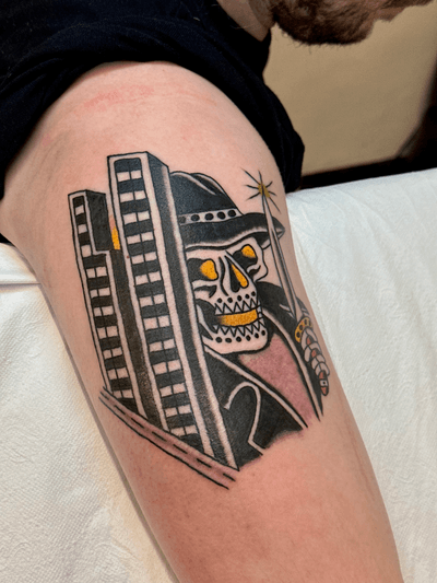 Traditional style tattoo by Jakob Isaac featuring a powerful grim reaper overlooking a city skyline.