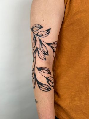 Explore the beauty of nature with this detailed vine motif tattoo, expertly executed in black ink by the talented artist Jack Howard.
