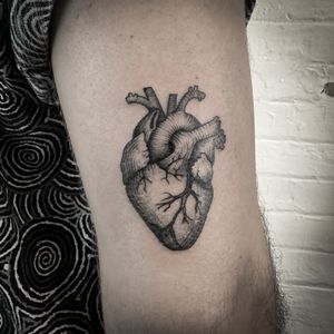 Jenny Dubet's illustrative woodcut design beautifully captures the intricate details of an anatomical heart in this stunning engraving tattoo.