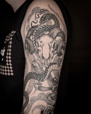 Intricately detailed design by Jenny Dubet featuring a snake, skull, and ram in dotwork style. Unique and eye-catching!