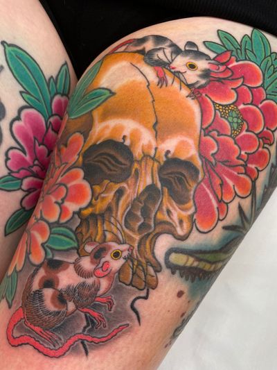 Skull and mice nestled within peony flowers 