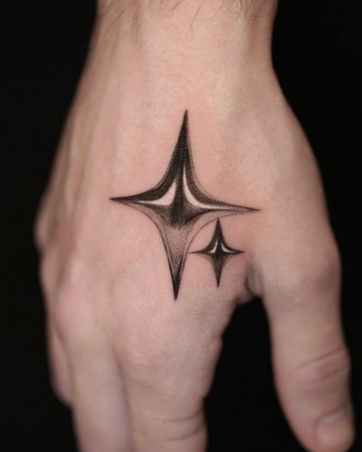 Gloria Gu showcases her expertise in micro-realism with this black and gray tattoo featuring a chrome metallic star design.