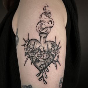 Beautiful black and gray heart tattoo by artist Jenny Dubet, featuring a sacred heart motif.