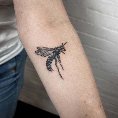 Get a stunning insect-themed tattoo with intricate details and bold lines, designed by the talented artist Jenny Dubet.