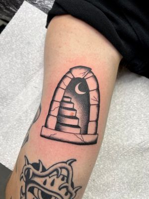 Admire the world beyond through Kayleigh Cole's illustrative traditional tattoo featuring a captivating window and stairs design.