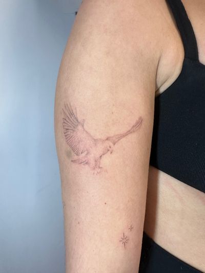 Experience the intricate detail and realism of this dotwork hand-poked eagle tattoo, expertly crafted by Alina Wiltshire. A true work of art.