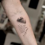 Capture the beauty of the night sky with this delicate black and gray micro-realism tattoo by Carolina Feodorov. Features a quote and fine line details.
