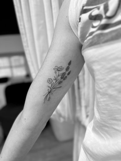 Experience the beauty of fine line art with this exquisite floral bundle tattoo. Each delicate petal and leaf crafted with precision by tattoo artist Aleks Fanta.