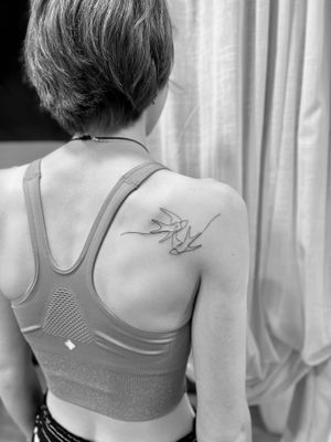 A beautiful and intricate single-line swallow tattoo by Aleks Fanta, perfect for those who appreciate minimalist designs.
