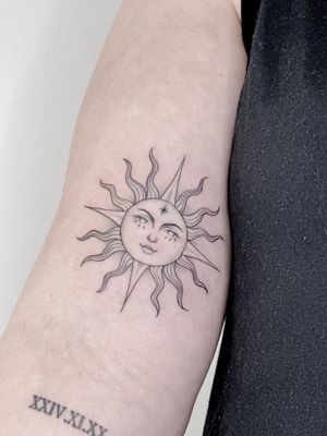 Capture the beauty of the sun with this fine line, illustrative tattoo by Carolina Feodorov. Radiate positive energy with this stunning design.