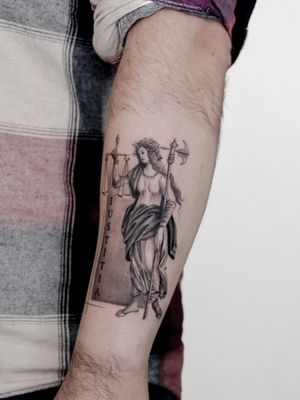 Stunning black and gray tattoo of a justice scale, meticulously detailed by artist Carolina Feodorov